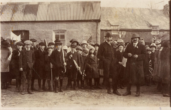Photograph of a group of men and children at a meeting